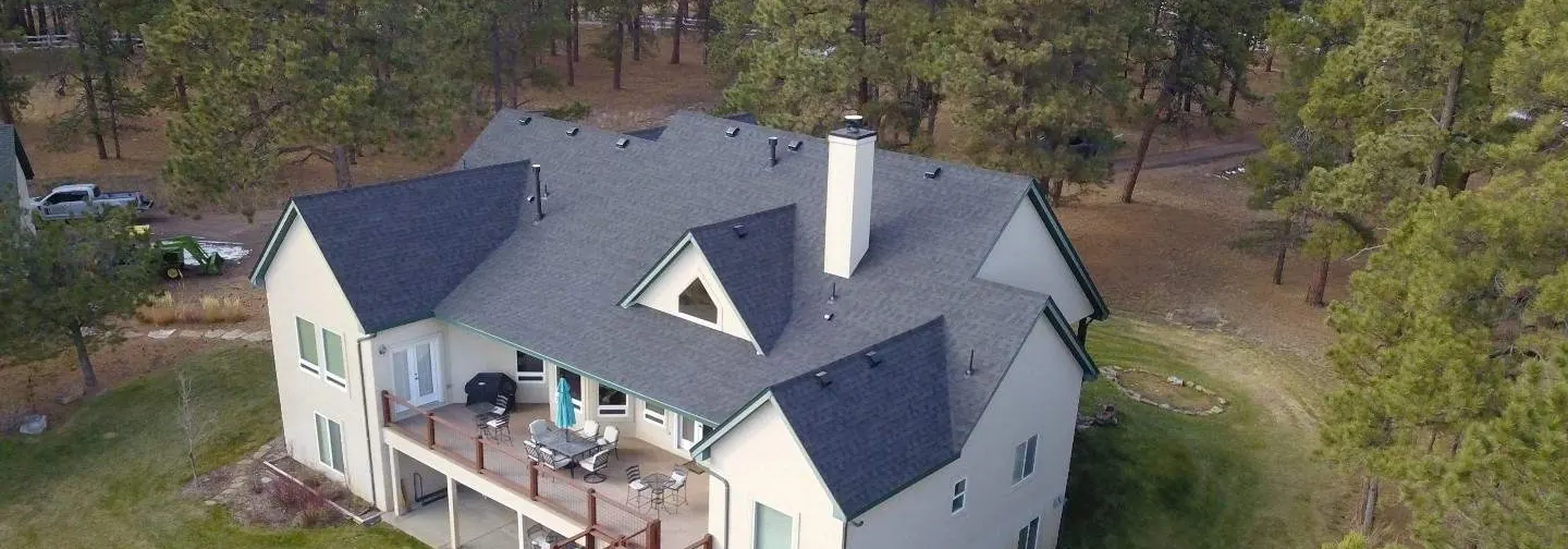 After, Elizabeth: aerial view of a large home among pines with its new Gen 3 roof
